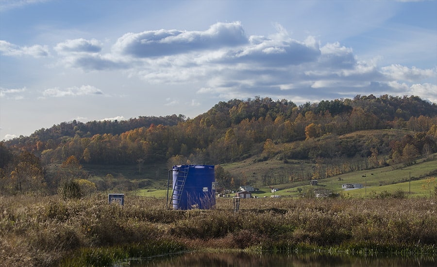 oil and gas storage tank in a mountain valley