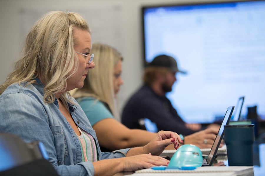 employees in the office working on their computers